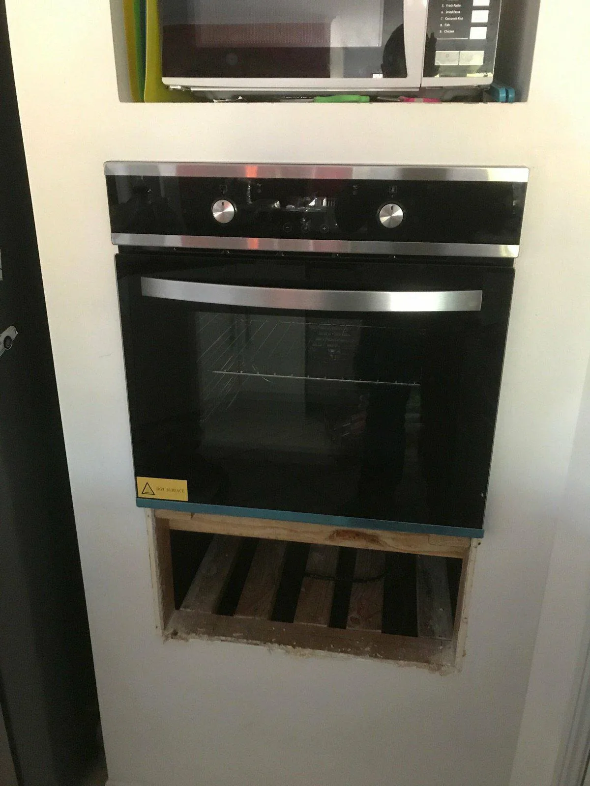 Black built-in wall oven installed in a new cabinet