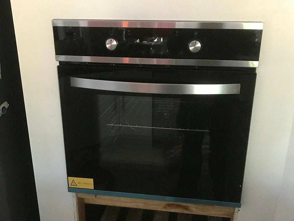 Black built-in wall oven installed into a new cabinet